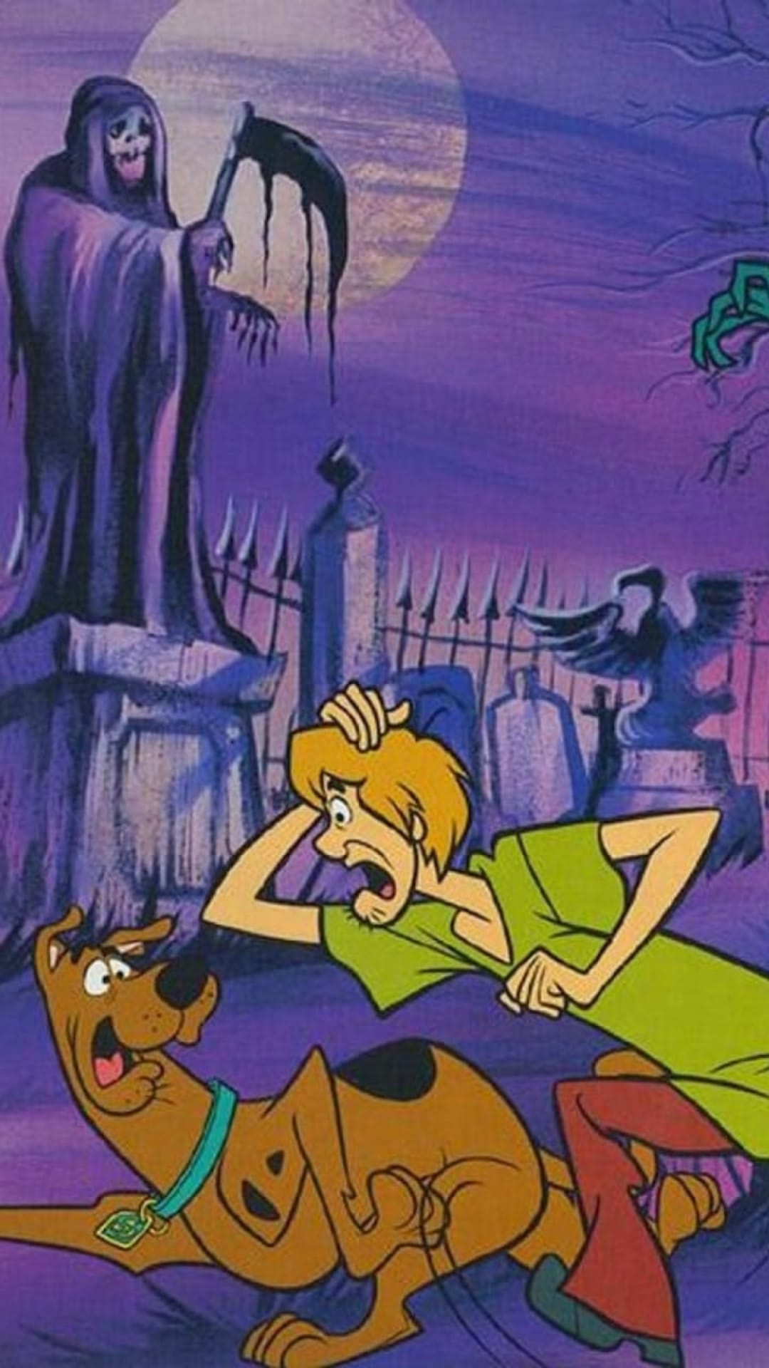 Shaggy and Scooby-Doo run past tombstones while a cloaked Grim Reaper chases them through a moonlit cemetery.