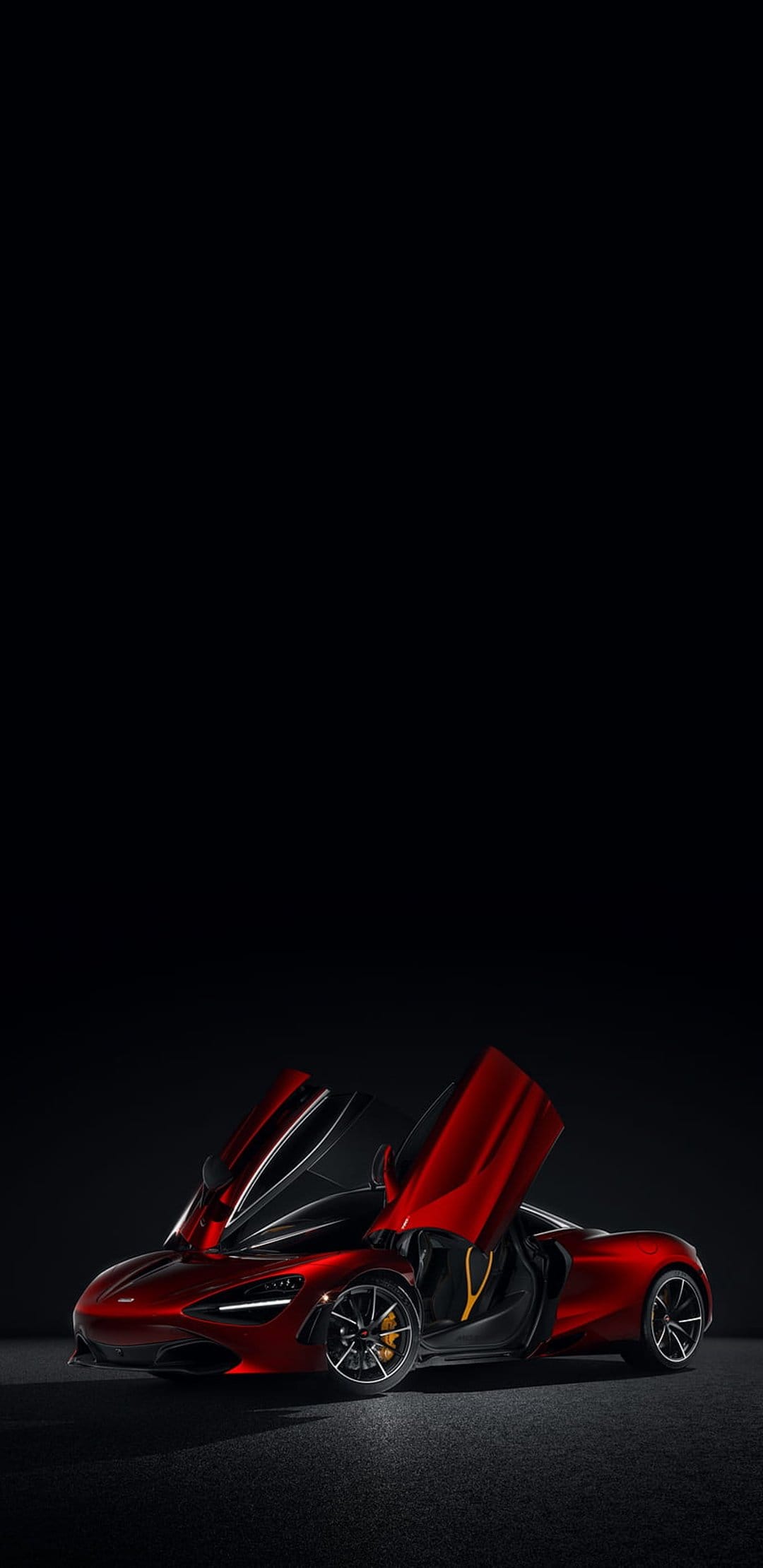 McLaren 720S supercar in red with open dihedral doors positioned against a solid black studio background.