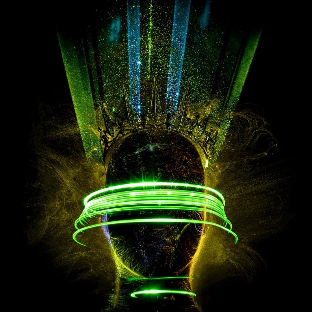 Dark crowned head surrounded by glowing neon green orbital light rings and shimmering blue rays on a black background.