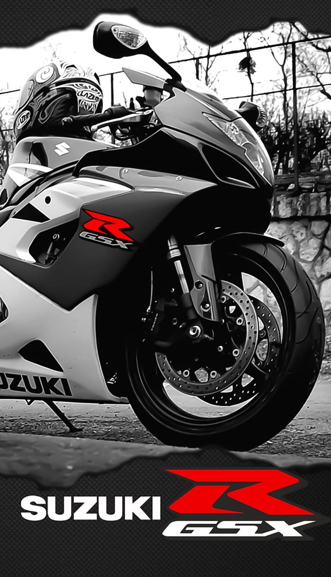 Suzuki GSX-R motorcycle with a red logo and a black rider's helmet against a blurred outdoor background.