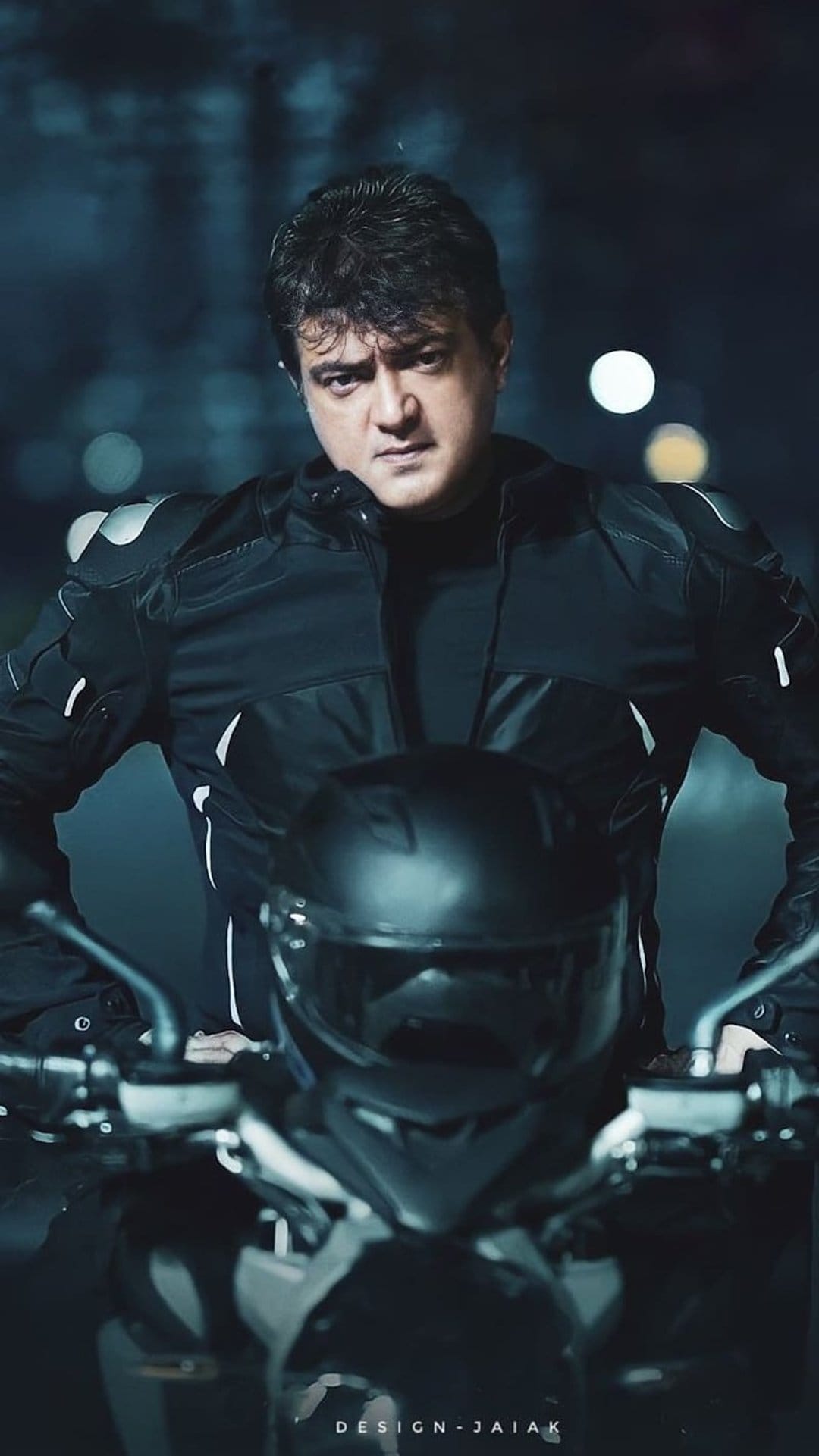 Biker in a black leather jacket sits on a motorcycle at night with blurred golden bokeh lights in the background.