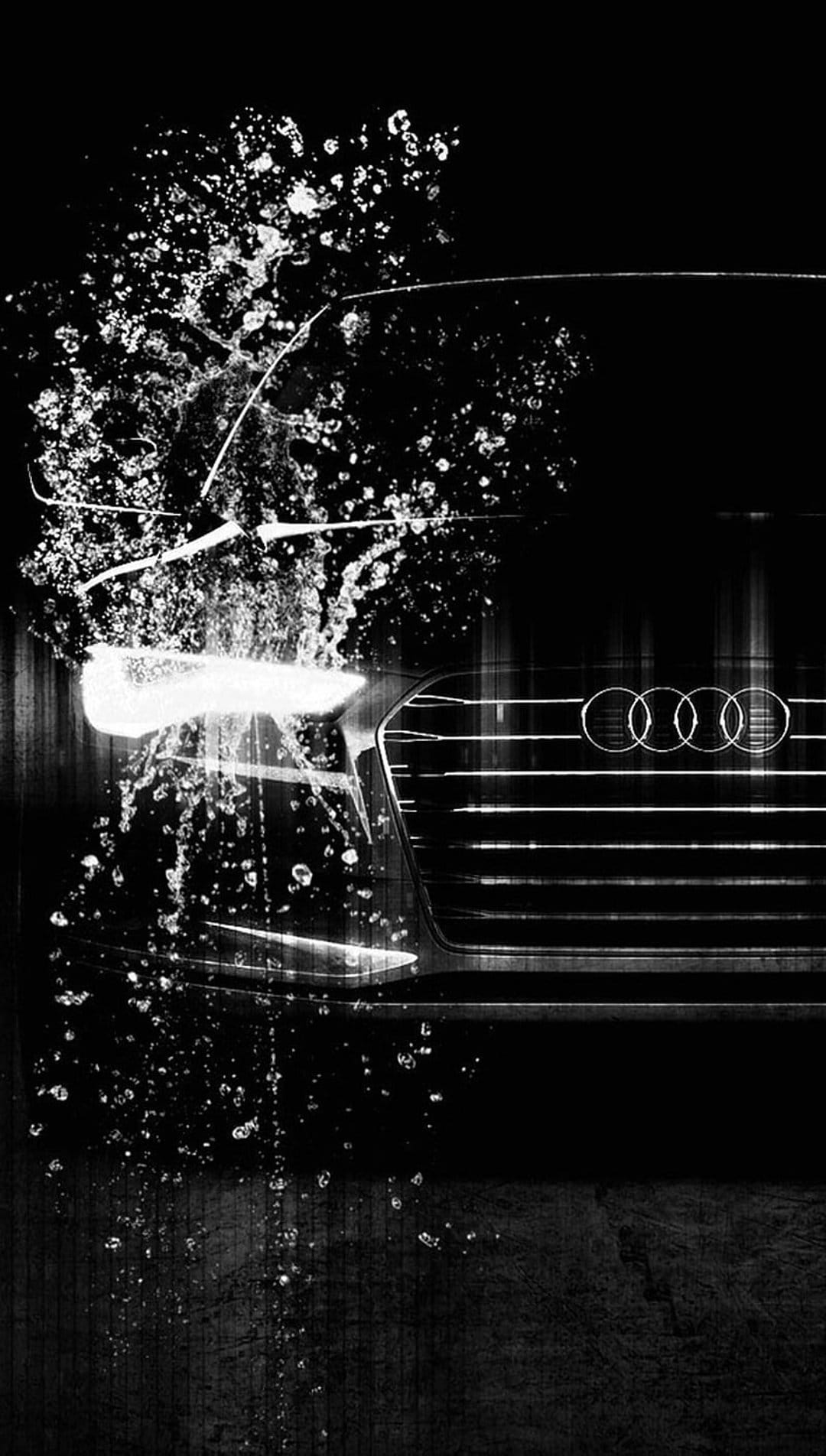 Audi logo and honeycomb grille are showered by a sharp water splash in a high-contrast black and white photo.