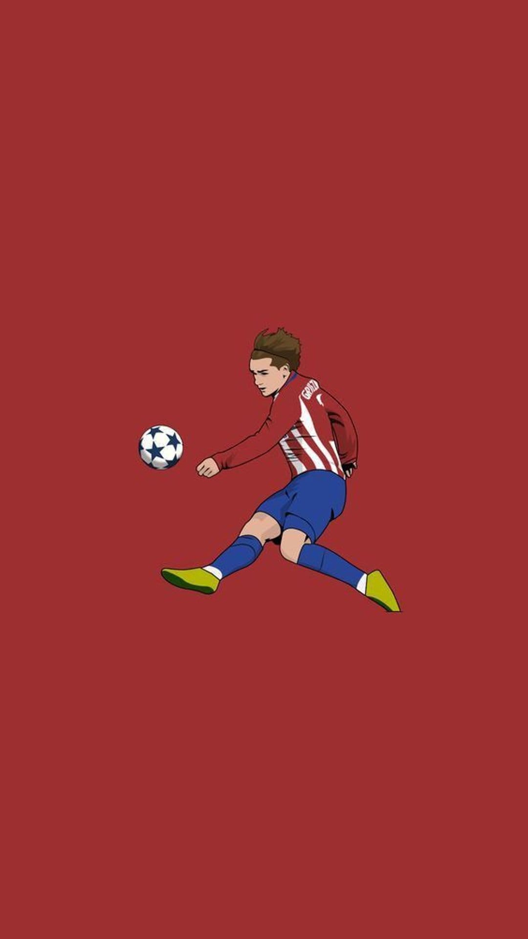 Antoine Griezmann kicks a soccer ball wearing a red striped jersey, blue shorts, and neon green boots.