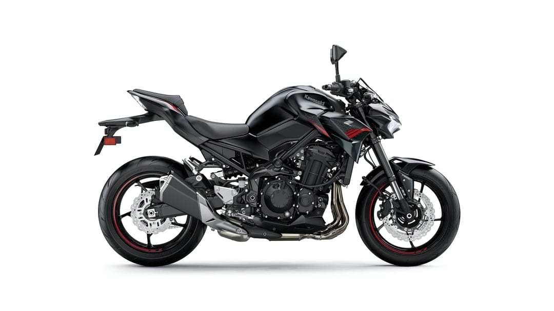 Side profile of a black Kawasaki Z900 motorcycle with red accents against a solid white background.