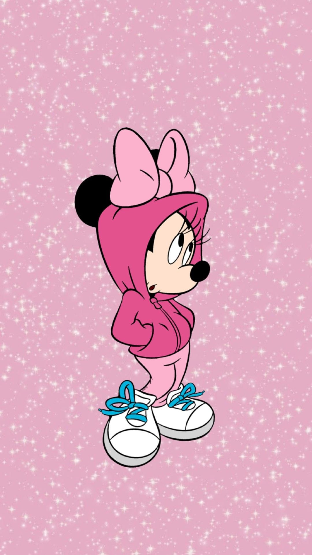 Minnie Mouse in a pink hoodie and sweatpants with blue-laced sneakers against a sparkling pink background.
