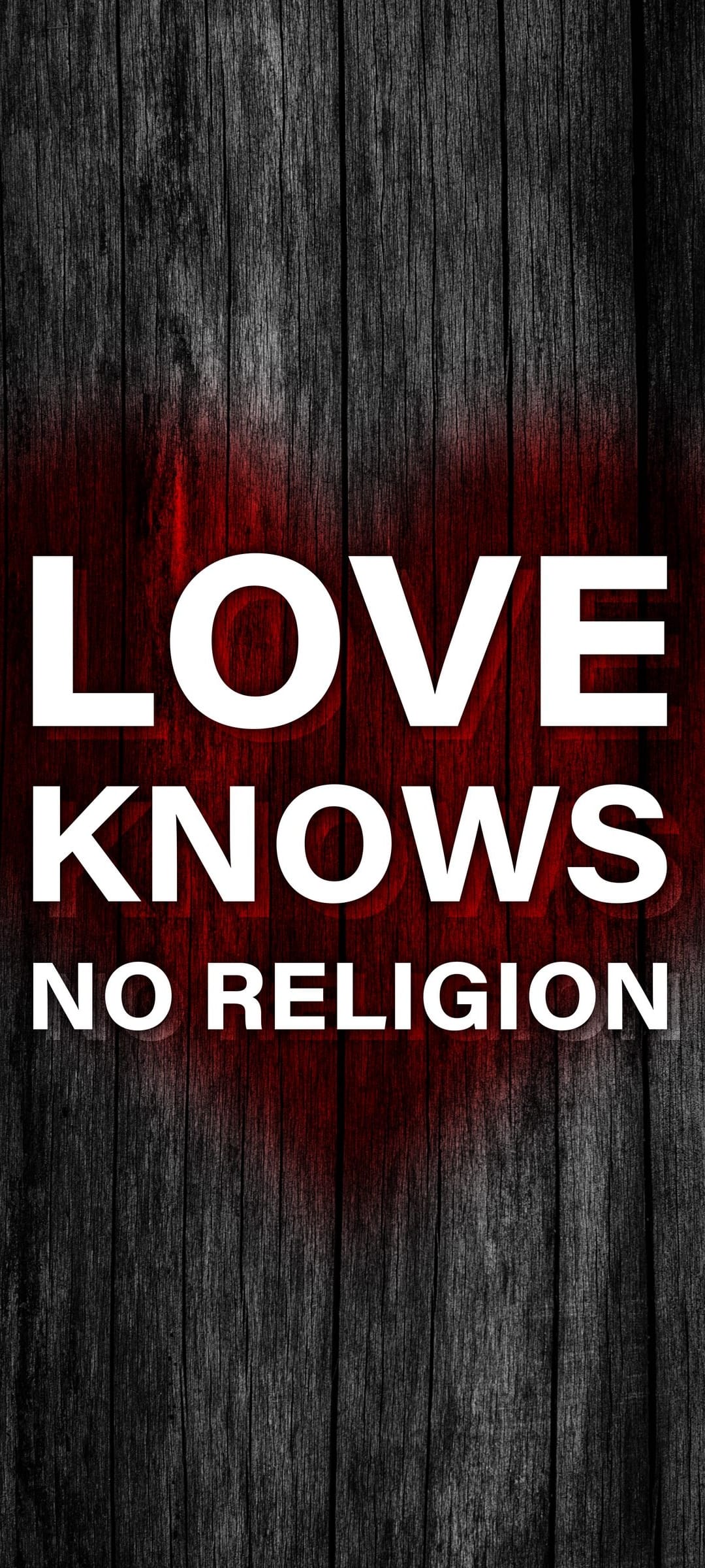 White block letters reading LOVE KNOWS NO RELIGION over dark wood planks with a faded red heart symbol.