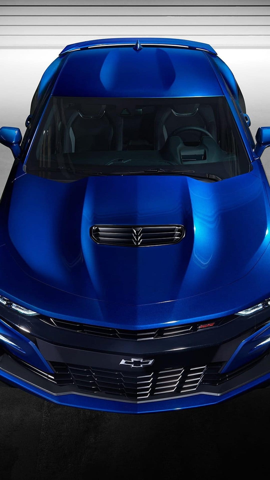 Blue Chevrolet Camaro SS front view featuring an aggressive black grille, sculpted hood, and sleek LED headlights.