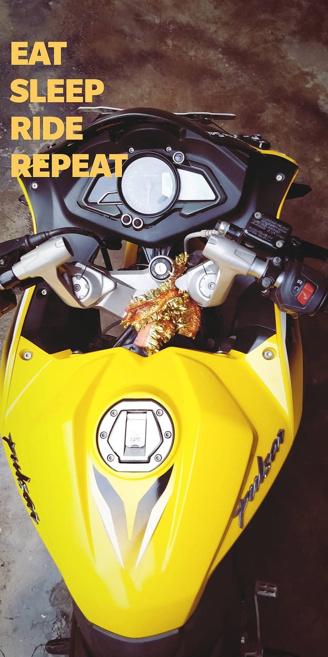 Yellow Bajaj Pulsar RS200 motorcycle handlebars and fuel tank with Eat Sleep Ride Repeat typography overlay.