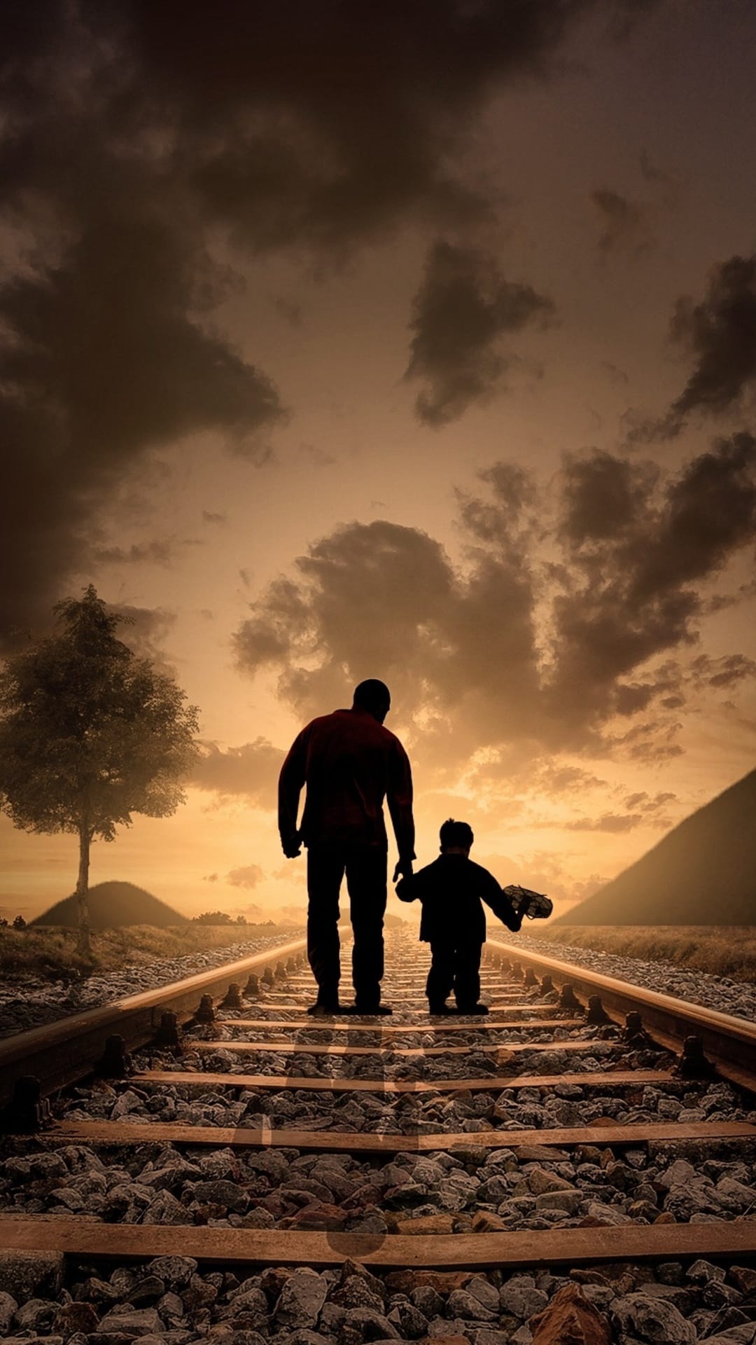 Two figures walk hand-in-hand along railway tracks silhouetted against a vibrant orange and purple sunset sky.