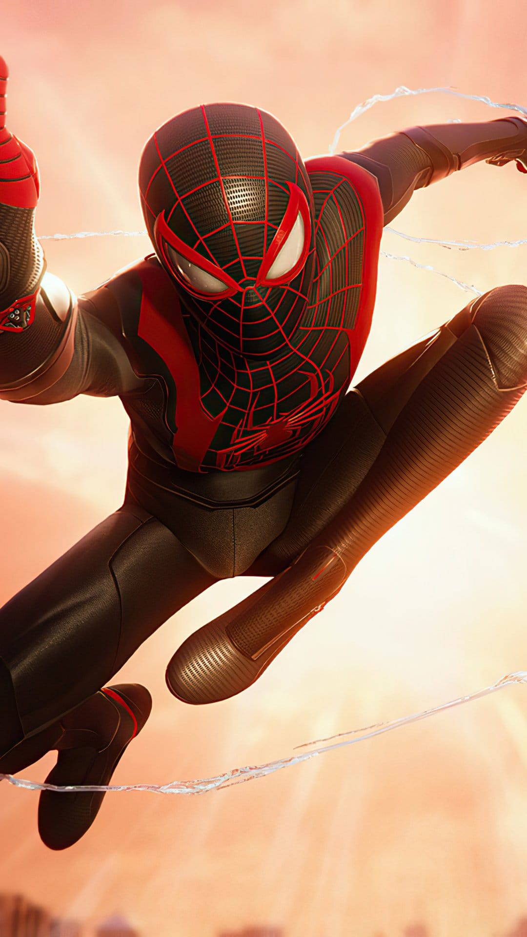 Miles Morales in a black and red suit leaps through a warm sunset sky with blurred city buildings below.