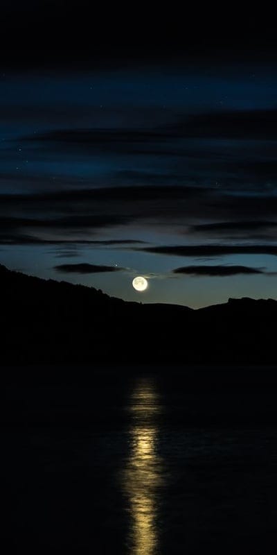 Moon, night, lake, reflection, serene, full moon, calm water, peaceful, landscape, nature, dark sky, clouds, moonlight, tranquil, outdoors, evening, quiet, beautiful, atmospheric, nocturnal.