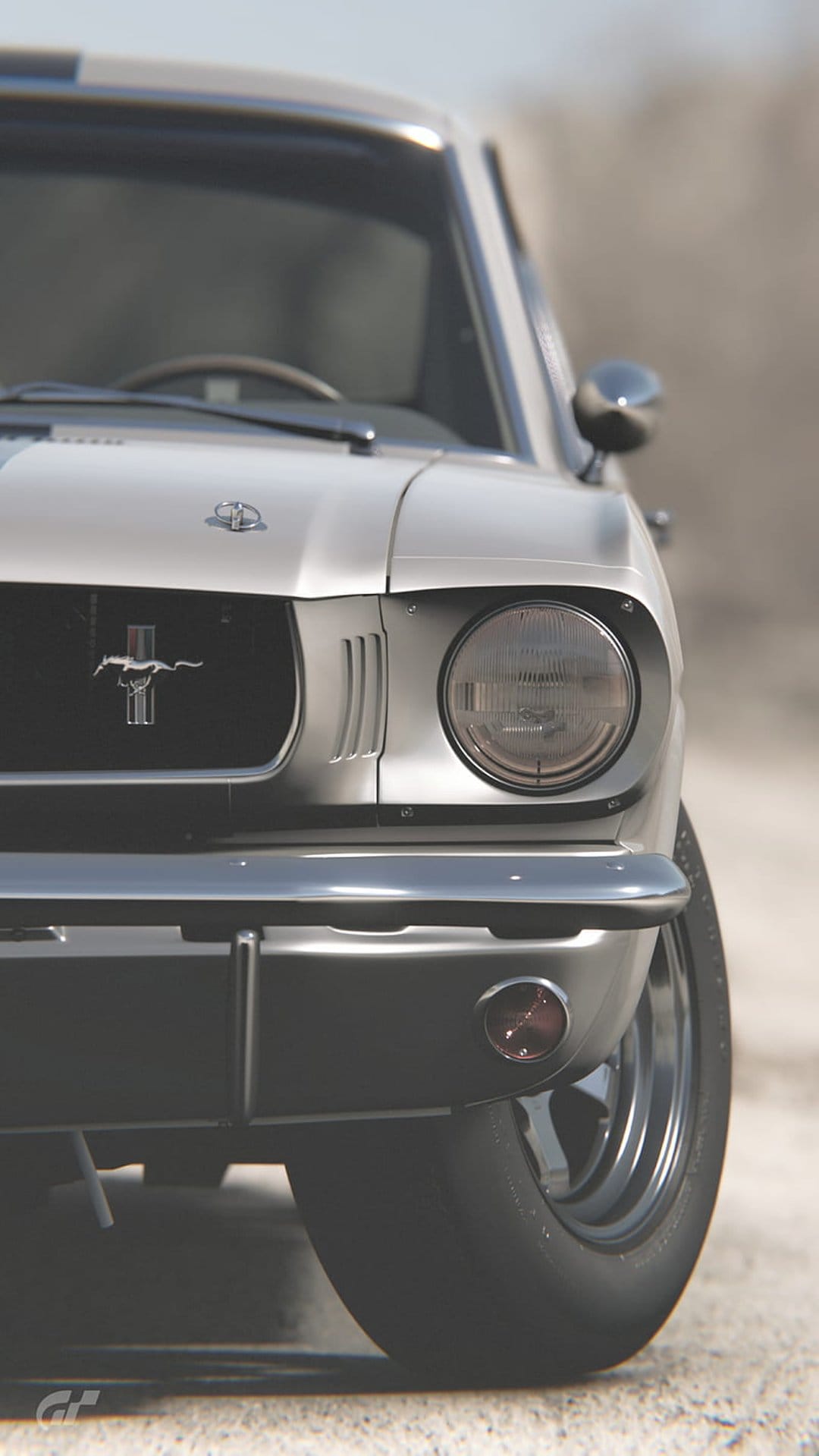 Silver Ford Mustang front grille with a chrome pony emblem, round glass headlight, and polished metal bumper.