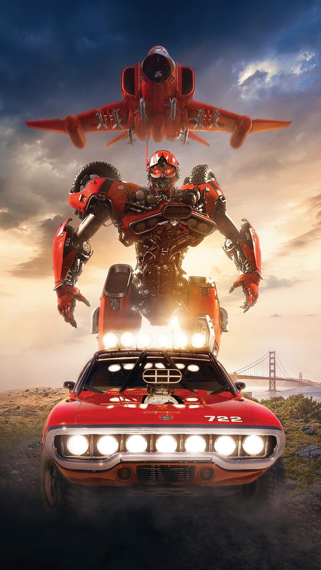 Red mechanical robot stands between a fighter jet and a muscle car with a bridge in the distant hazy sky.