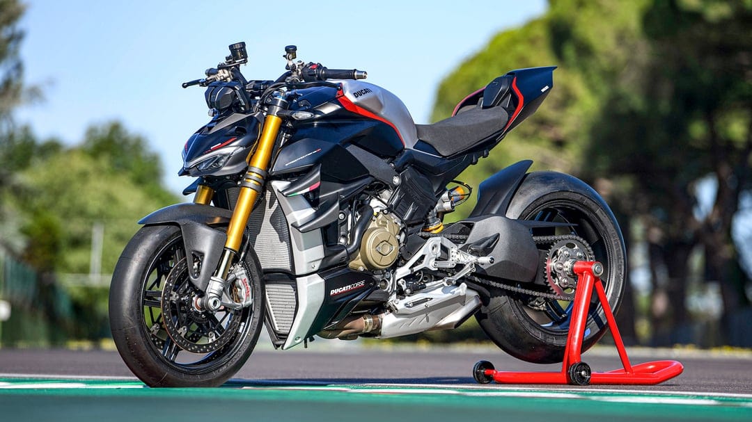 Ducati Streetfighter V4 SP2 superbike with matte black and silver finish parked on a red racing stand on a track.