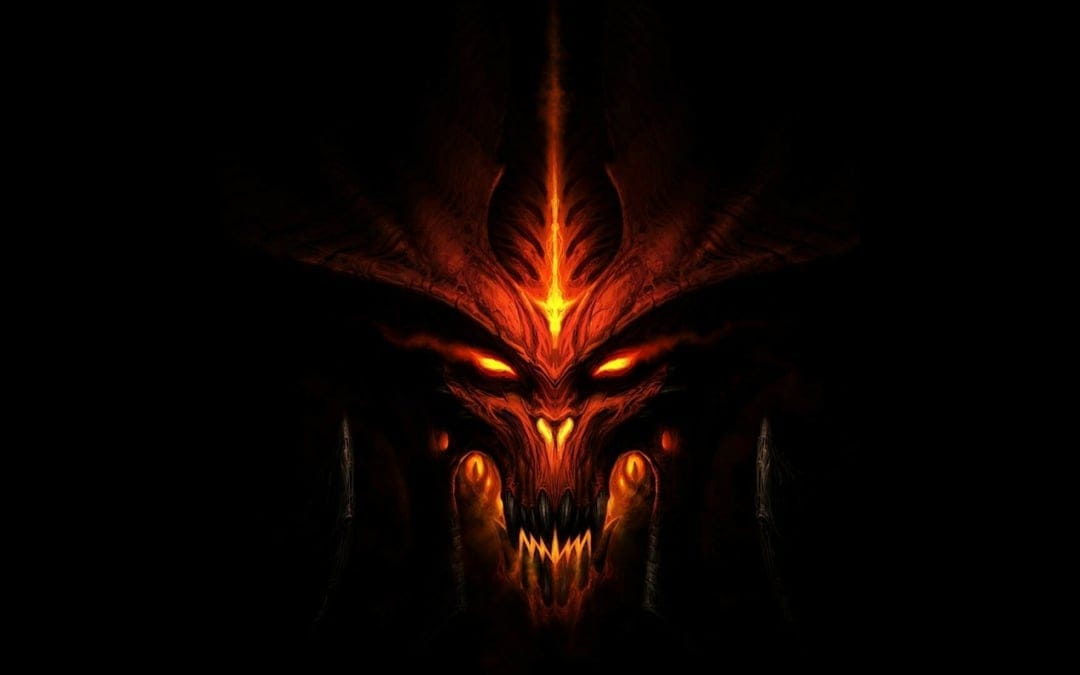 Fiery demonic face with glowing orange eyes and sharp teeth emerging from a pitch-black background in close-up.