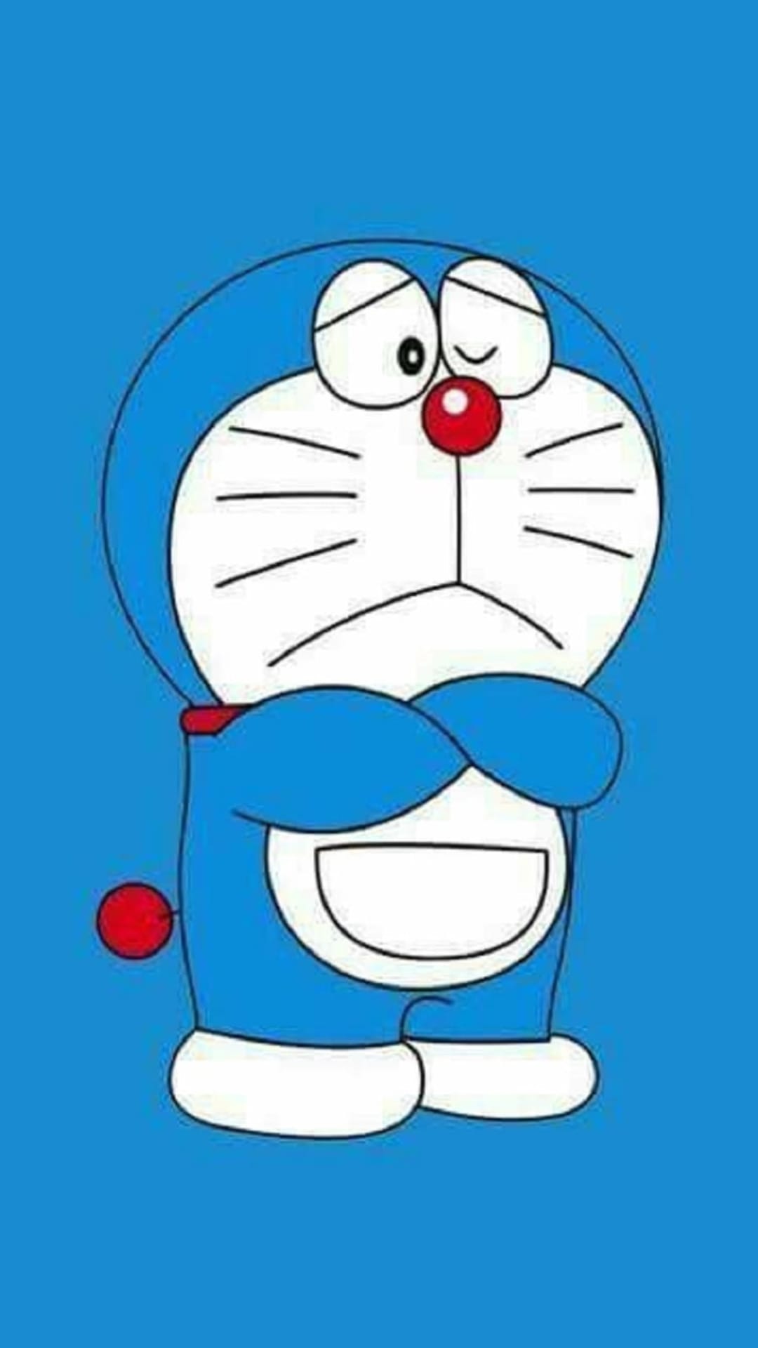 Doraemon stands with a sad expression and folded arms against a solid blue background in a vertical composition.
