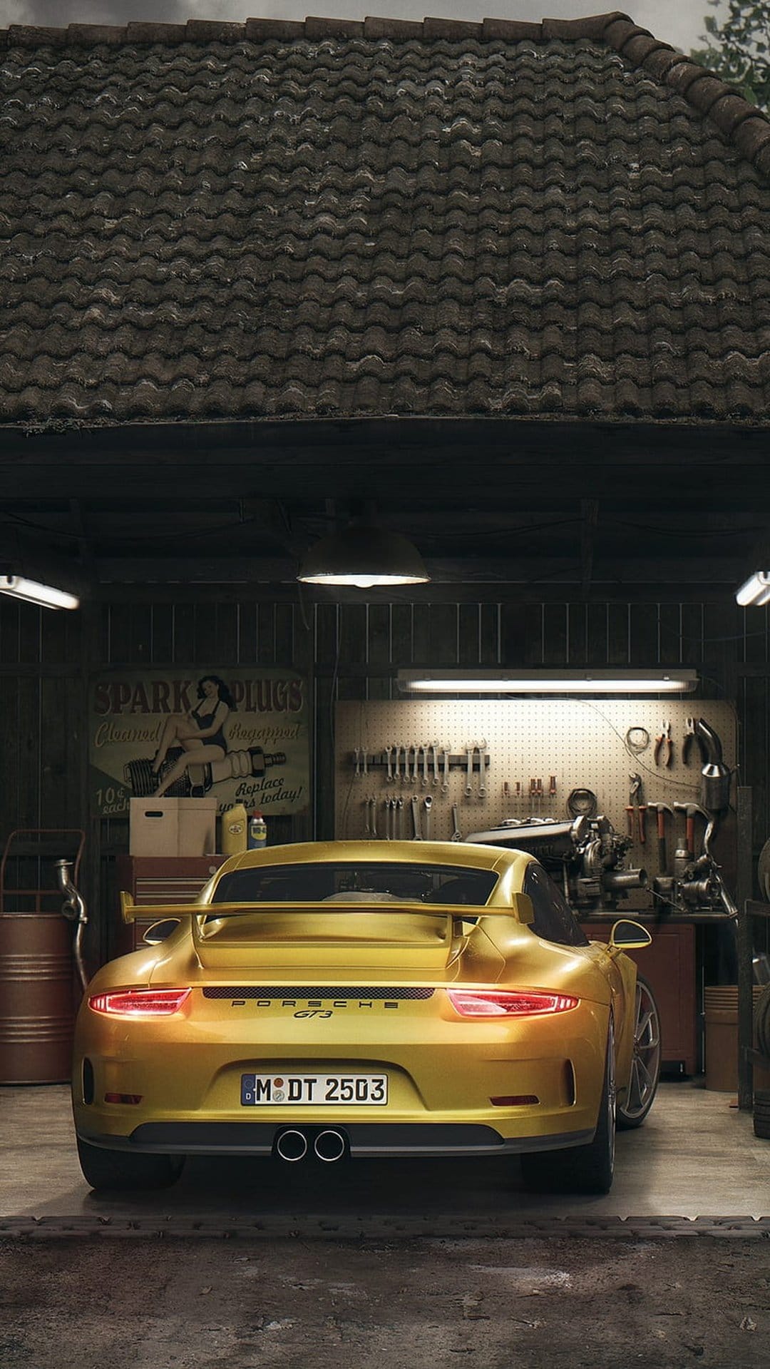 Porsche GT3 in metallic gold sits inside a dim workshop featuring organized tools and weathered ceiling tiles.
