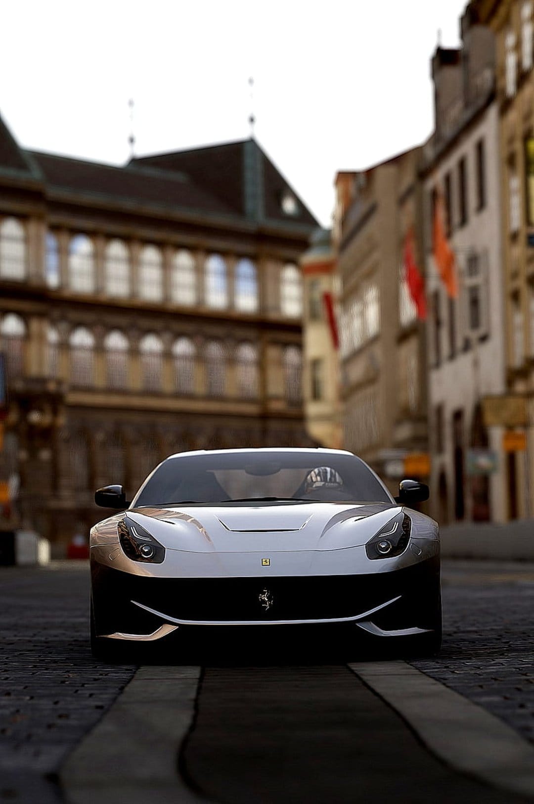 Ferrari F12berlinetta sports car parked on a European cobblestone street with historic buildings and red flags.