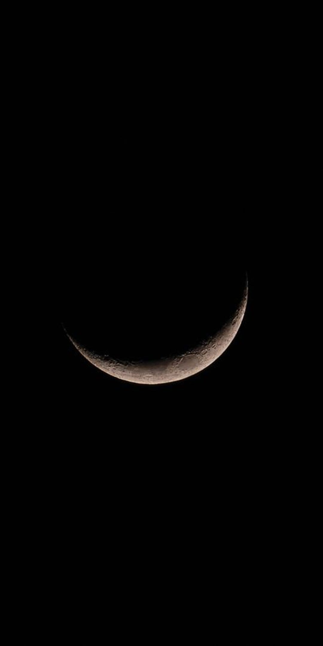 Crescent moon sliver with visible surface craters centered on a solid black background for a phone screen.