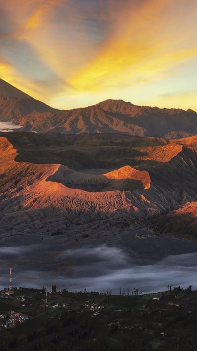 Mount Bromo, Indonesia, volcano, sunset, mountains, nature, dramatic, serene, outdoor, beautiful, natural beauty, fog, tranquil, picturesque, landscape, travel, scenic, caldera, golden hour, light rays, vibrant