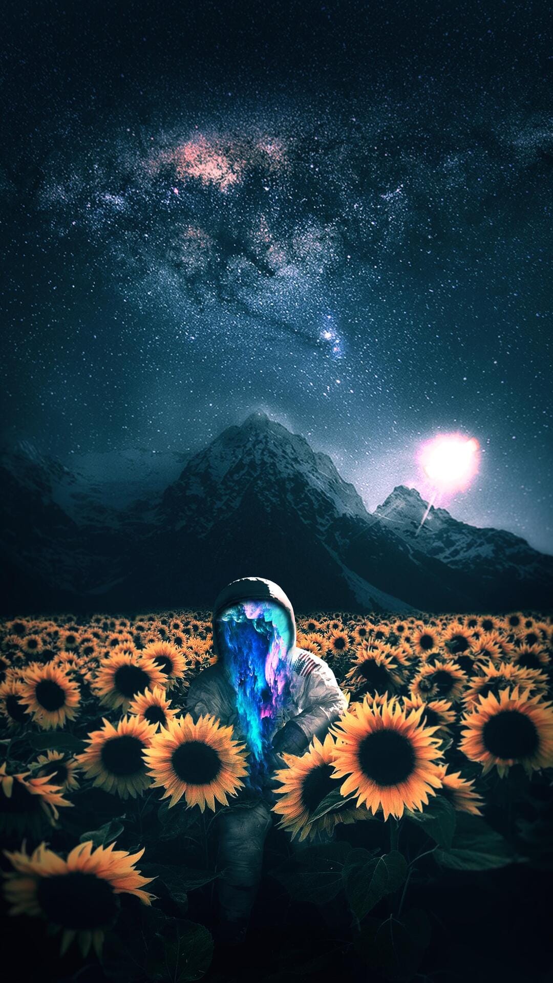 Person with a glowing face stands in a sunflower field beneath the Milky Way and jagged mountain peaks.