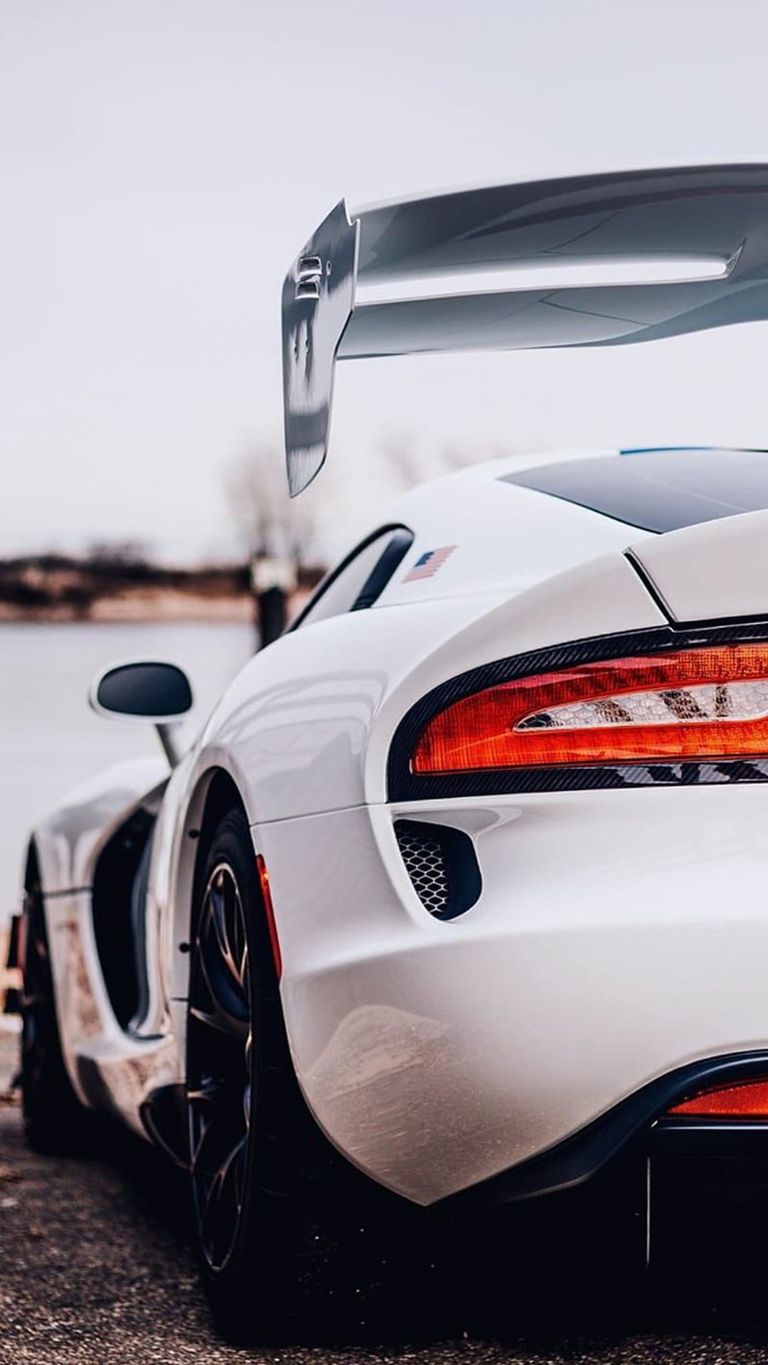 White Dodge Viper ACR Extreme spoiler and taillight details with a small American flag on the rear window.