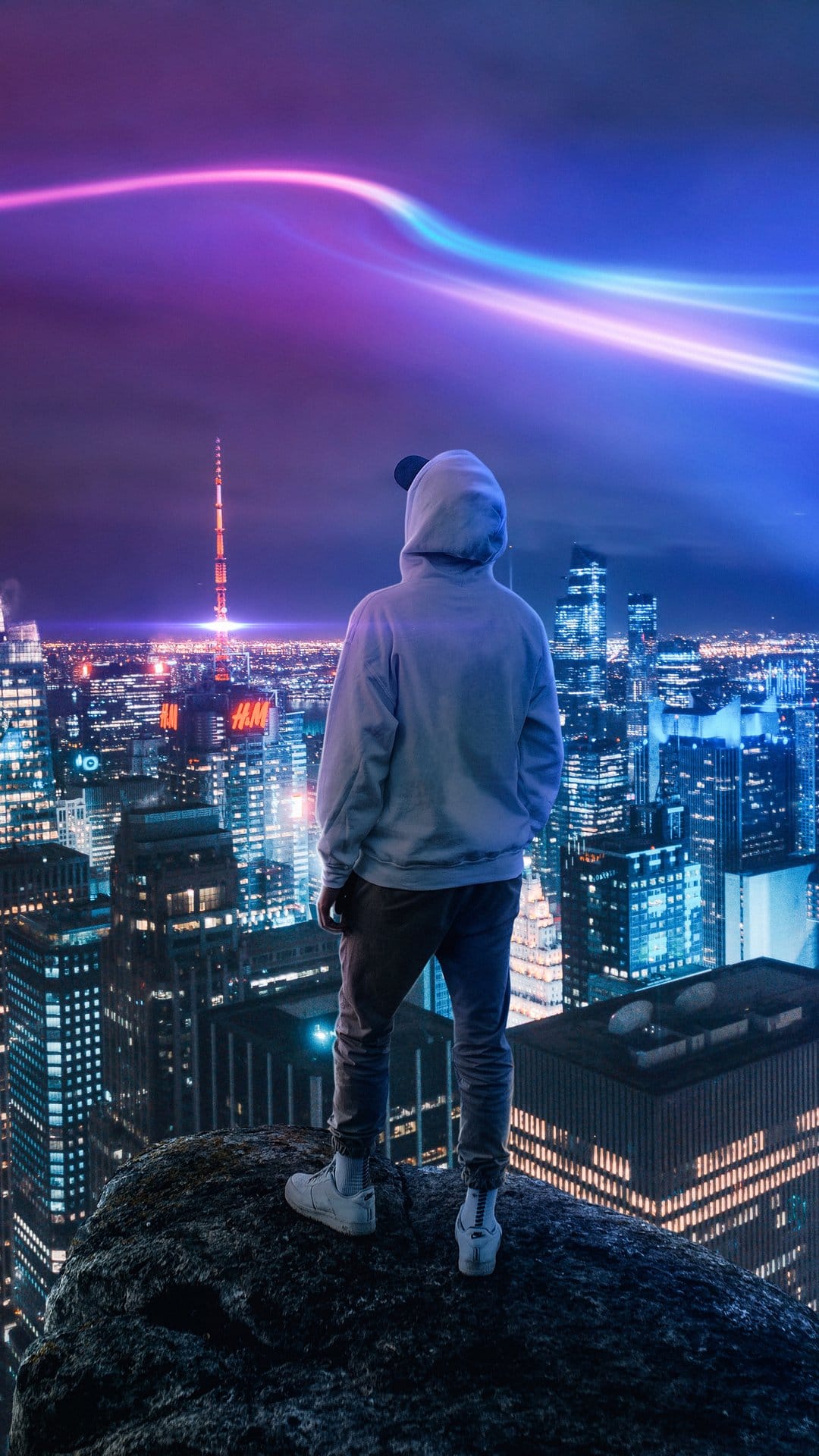 Man silhouetted against a neon city skyline with purple light streaks and towering skyscrapers at night.