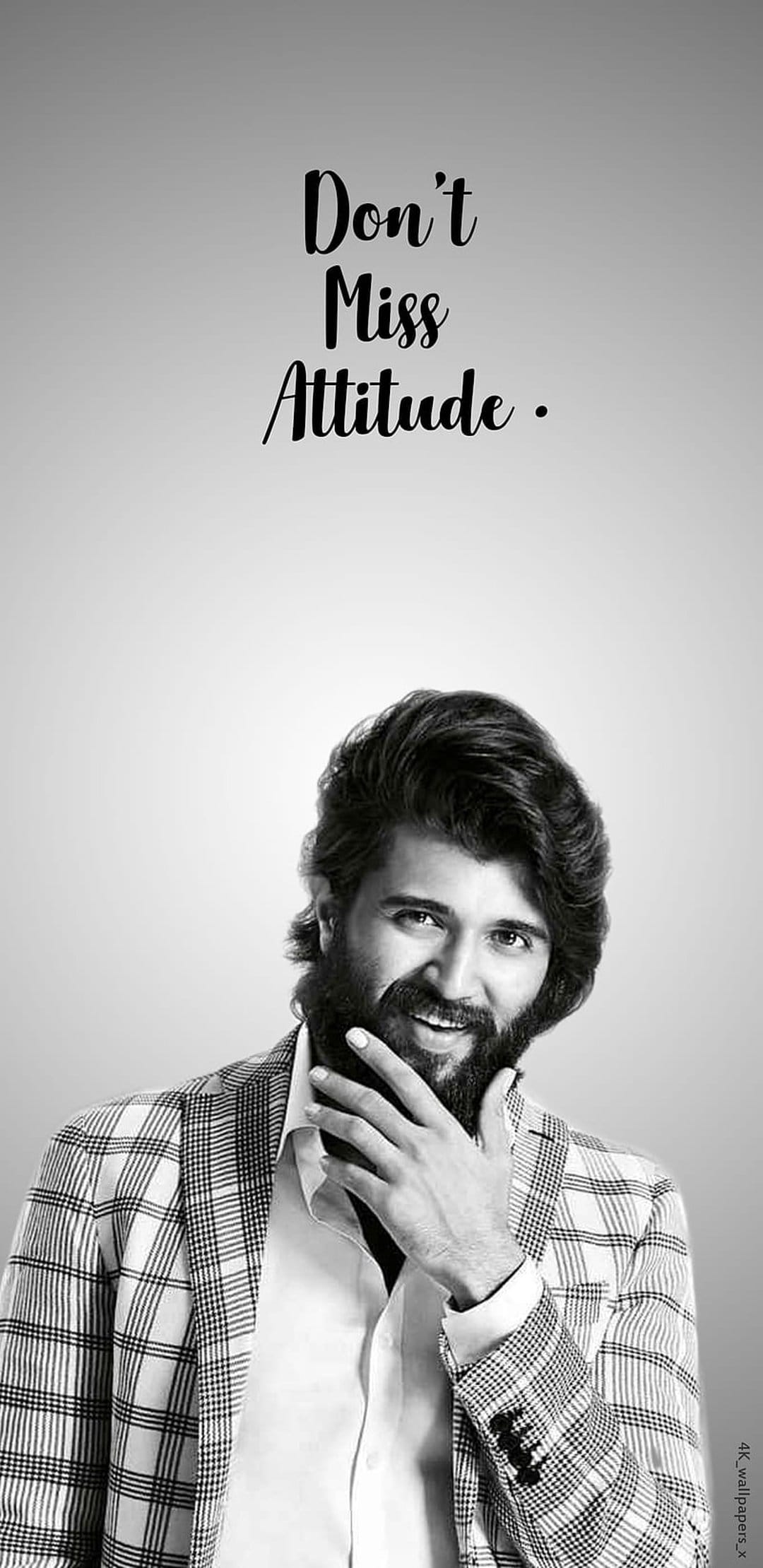 Vijay Deverakonda wearing a checkered blazer with "Don't Miss Attitude" text in a monochrome portrait.