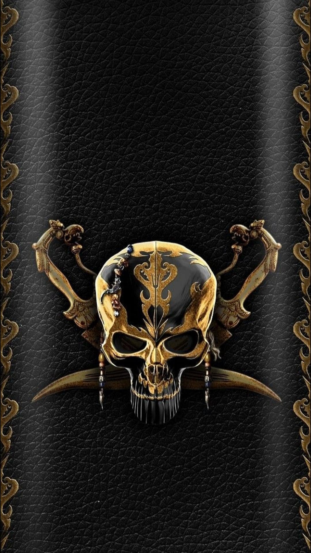 Gilded gold skull with ornate patterns and crossed sabers over a textured black leather background with borders.