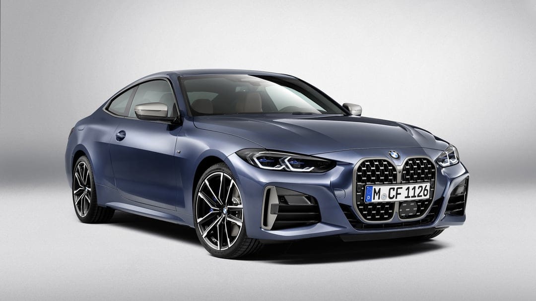 Matte blue BMW 4 Series Coupe with large vertical grille and LED headlights on a minimalist grey background.