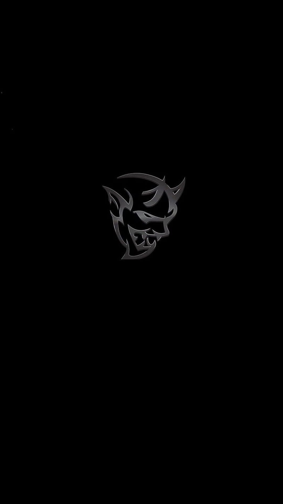 Silver metallic Demon car logo with horns centered on a black background for a vertical mobile phone screen.