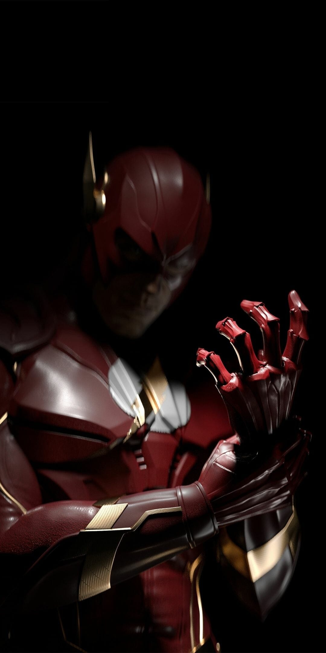 Armored red superhero in gold-trimmed plating gazes at his hand against a dark, high-contrast background.