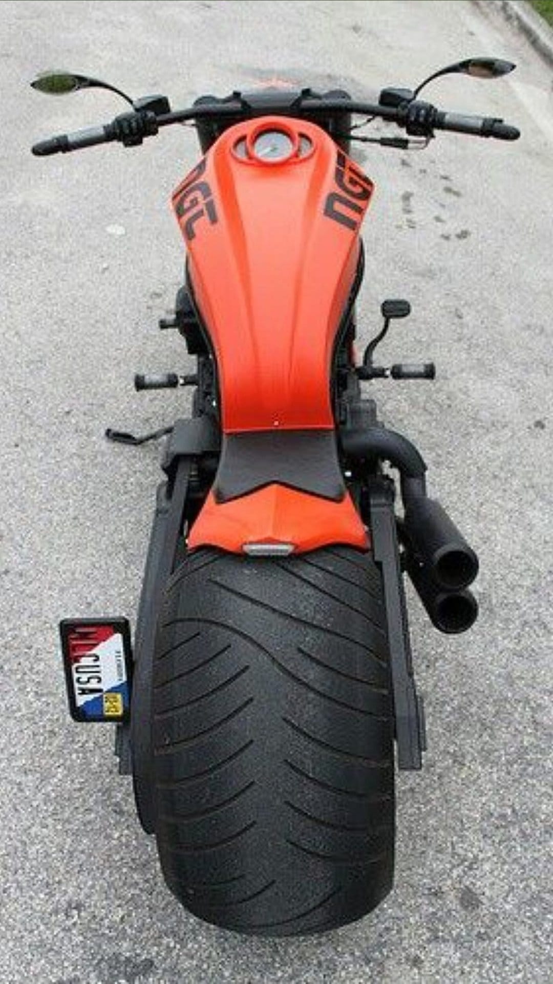 Orange Harley-Davidson Nightrod motorcycle with a wide rear tire and dual exhaust viewed from a top-down angle.