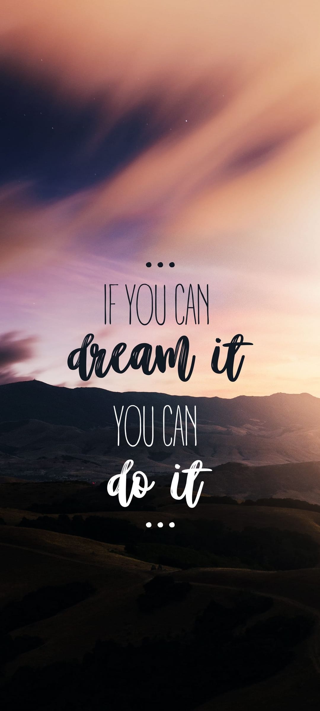 Jagged mountain peaks under a pink and orange sunset sky with text saying If You Can Dream It You Can Do It.