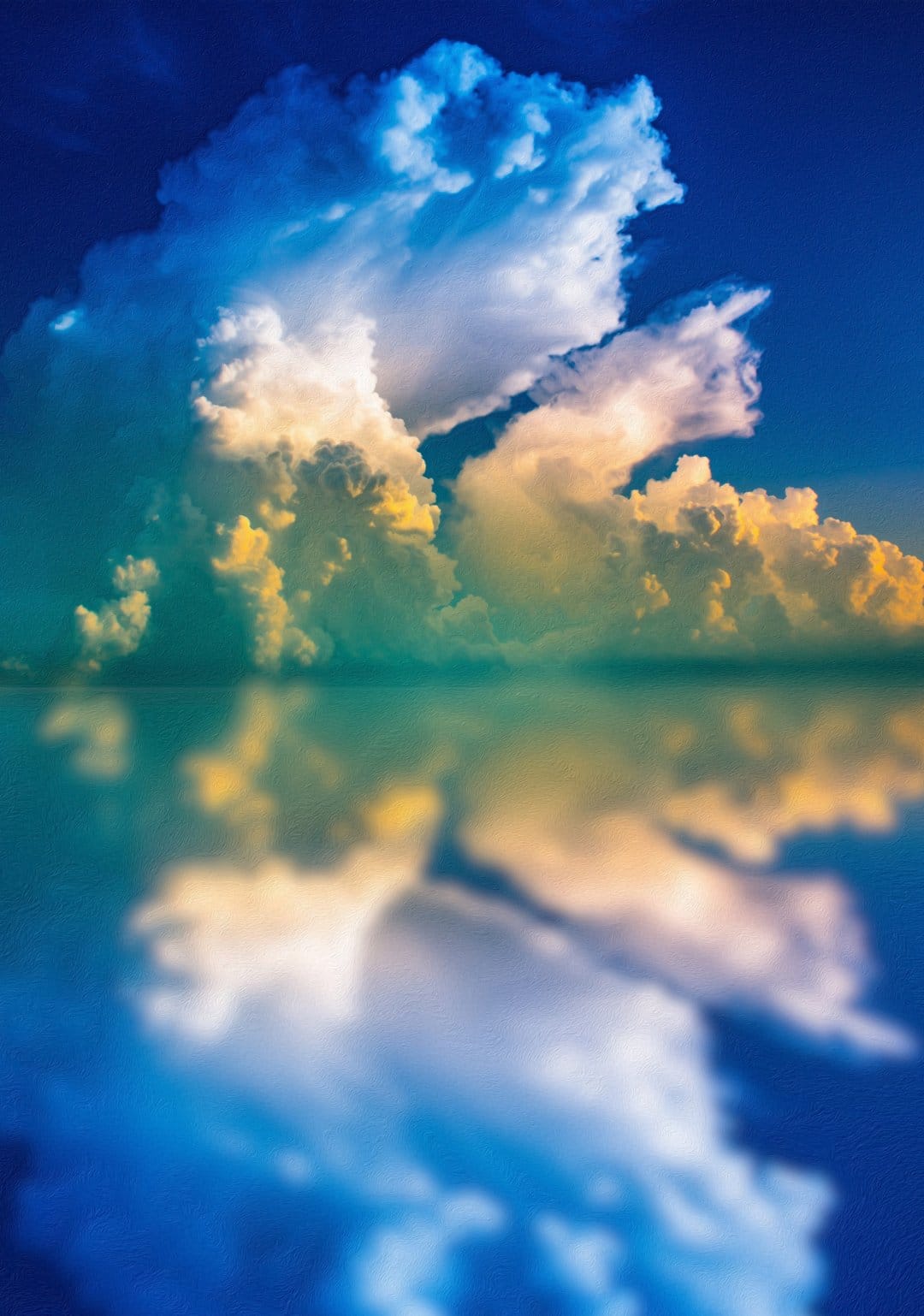 Sun-kissed yellow clouds reflect on a calm blue sea surface under a clear horizon in a symmetrical landscape.