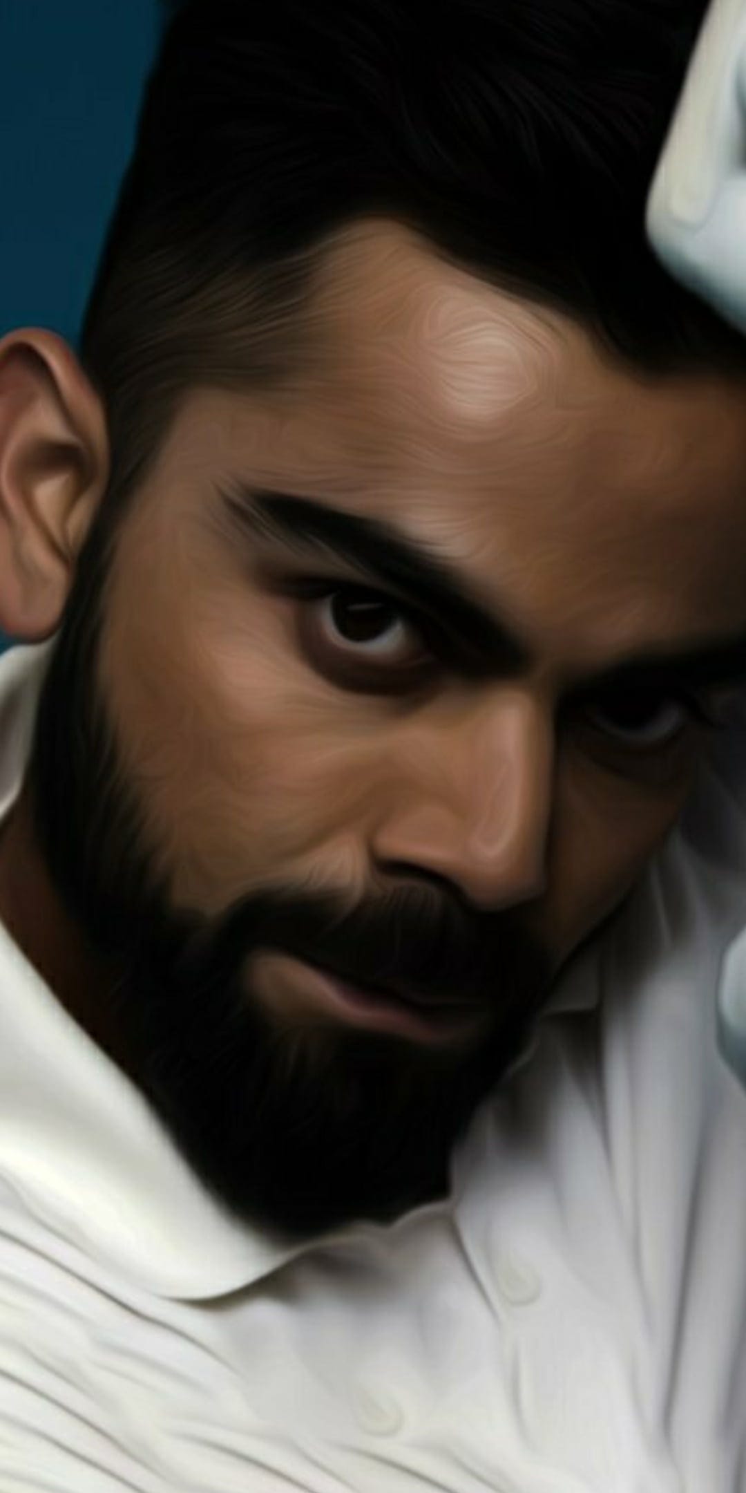 Virat Kohli with a groomed beard and focused expression stares forward against a soft blue textured background.