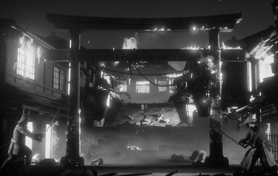 Two samurai warriors facing each other with katanas under a massive burning torii gate in a smoky village.