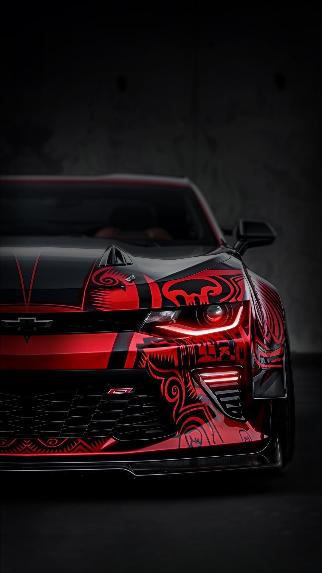 Chevrolet Camaro with red and black tribal patterns on the hood and headlights against a dark background.