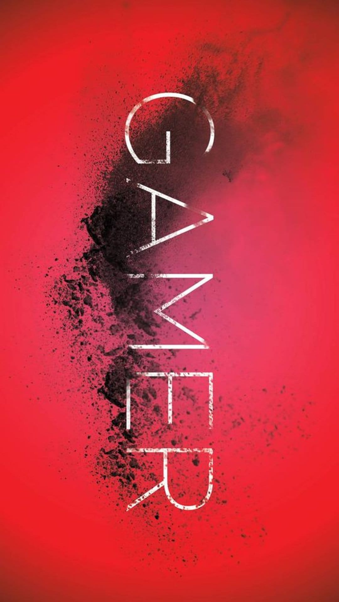 Black vertical GAMER text disintegrating into dark particles against a vibrant red and pink gradient backdrop.
