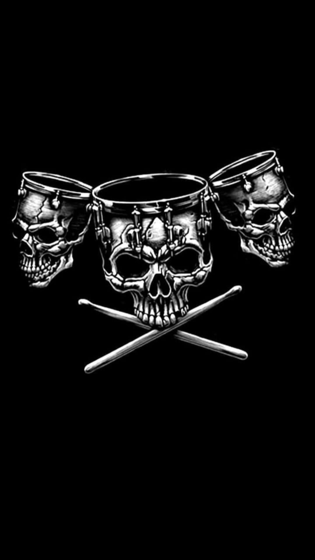 Three skull-shaped drums sit behind two crossed drumsticks with detailed metallic shading and dark shadows.