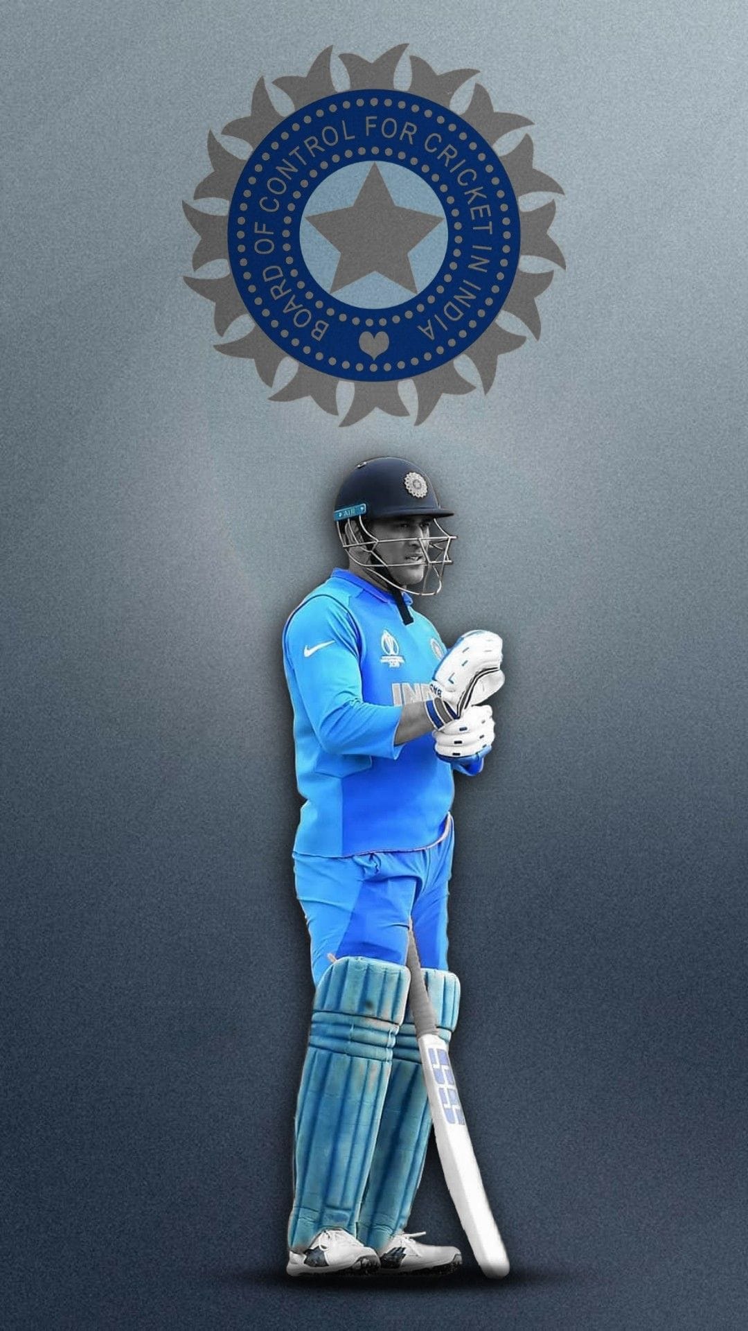 MS Dhoni stands in a blue India cricket uniform with pads and a bat against a grey BCCI emblem background.