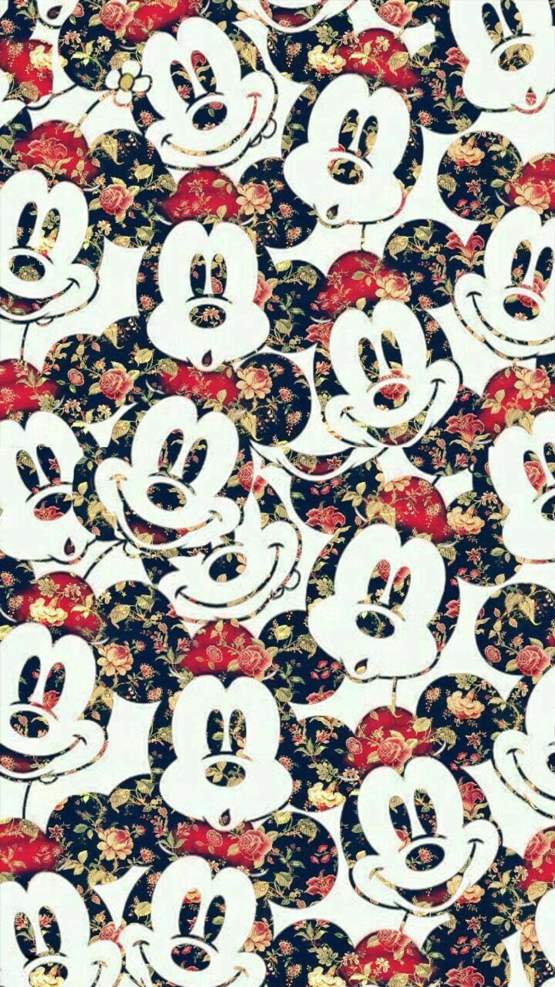 Mickey Mouse silhouettes nestled among red and yellow roses on a navy blue botanical wallpaper background.