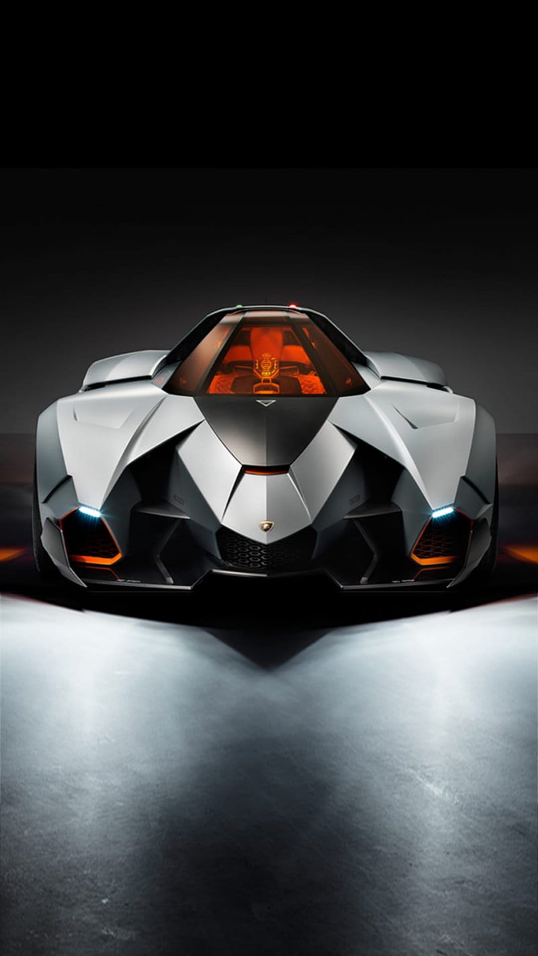 Lamborghini Egoista concept car featuring a sharp silver front bumper, LED lights, and a bright orange interior.