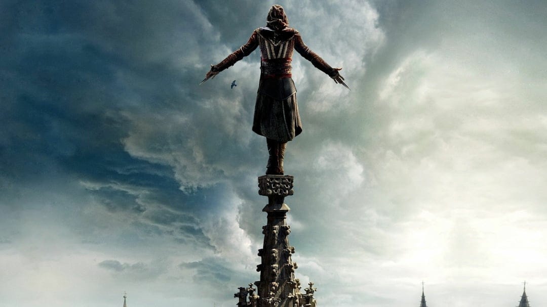 Assassin with outstretched arms standing on a tall stone spire against a moody, overcast cloudy sky.