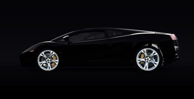 Black Lamborghini sports car with silver wheels and yellow brake calipers against a dark studio backdrop.