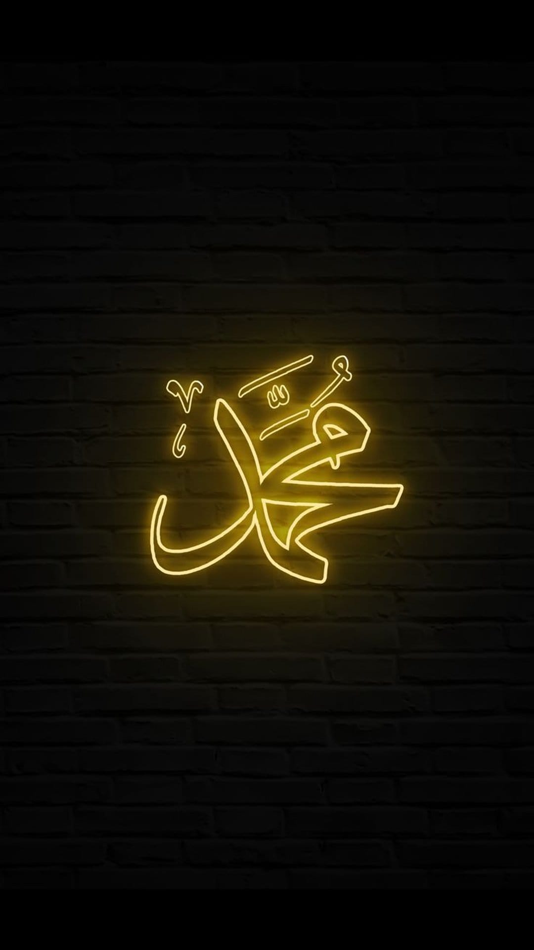 Muhammad in yellow neon Arabic calligraphy glows with a warm light against a dark, textured brick wall surface.