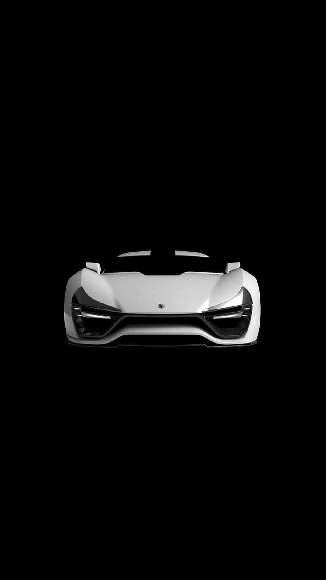 White futuristic sports car with glowing LED headlights positioned centrally against a solid black background.