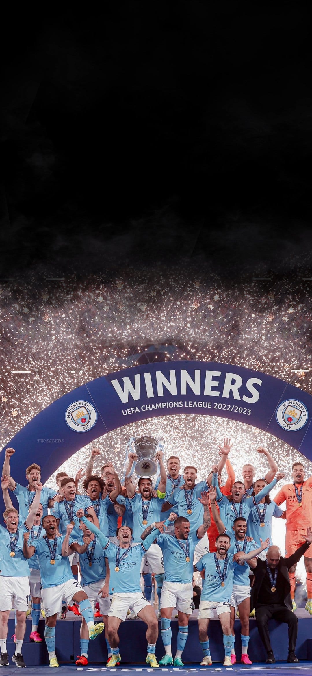 Manchester City players lift the silver Champions League trophy under glowing fireworks and falling confetti.