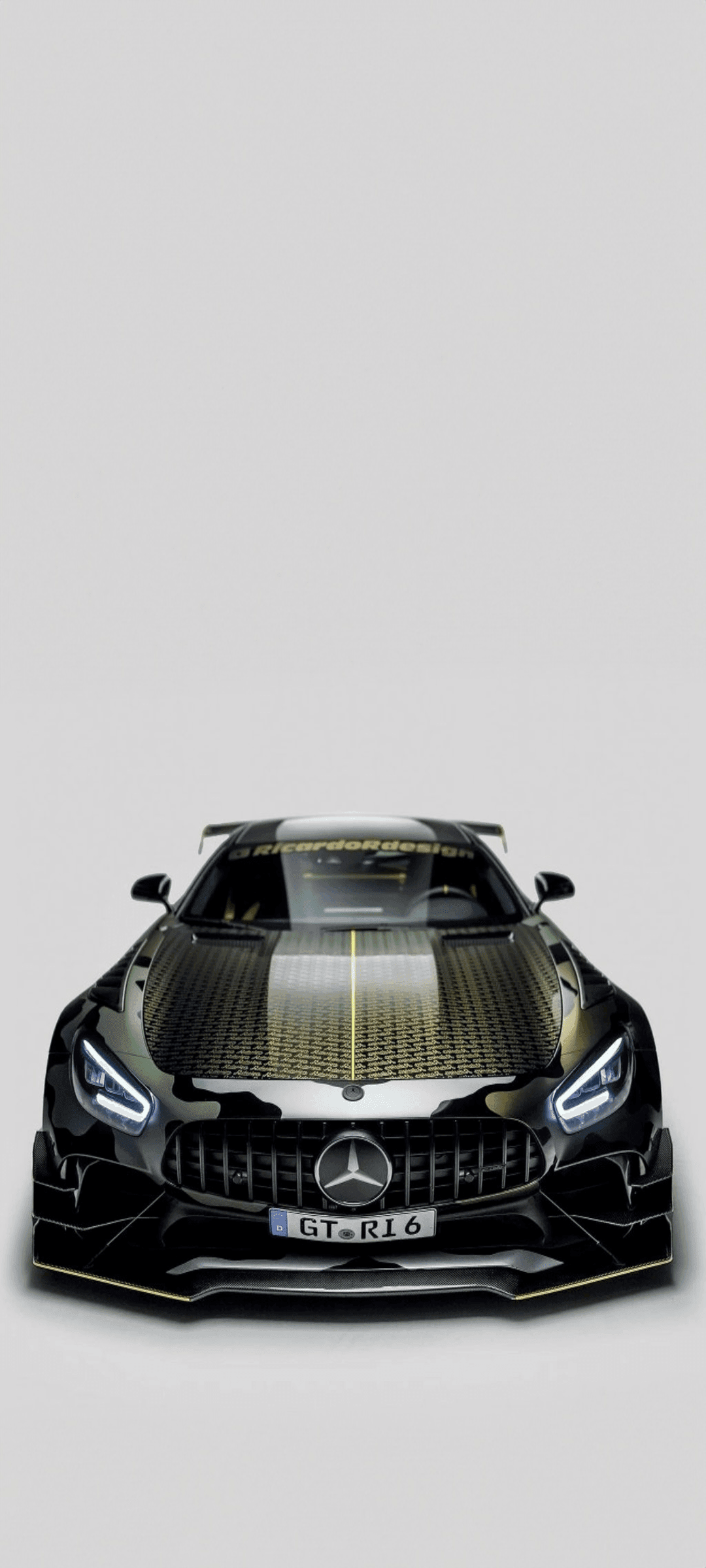 Mercedes-AMG GT R featuring a gold and grey camouflage wrap with custom hood vents and glowing LED headlights.