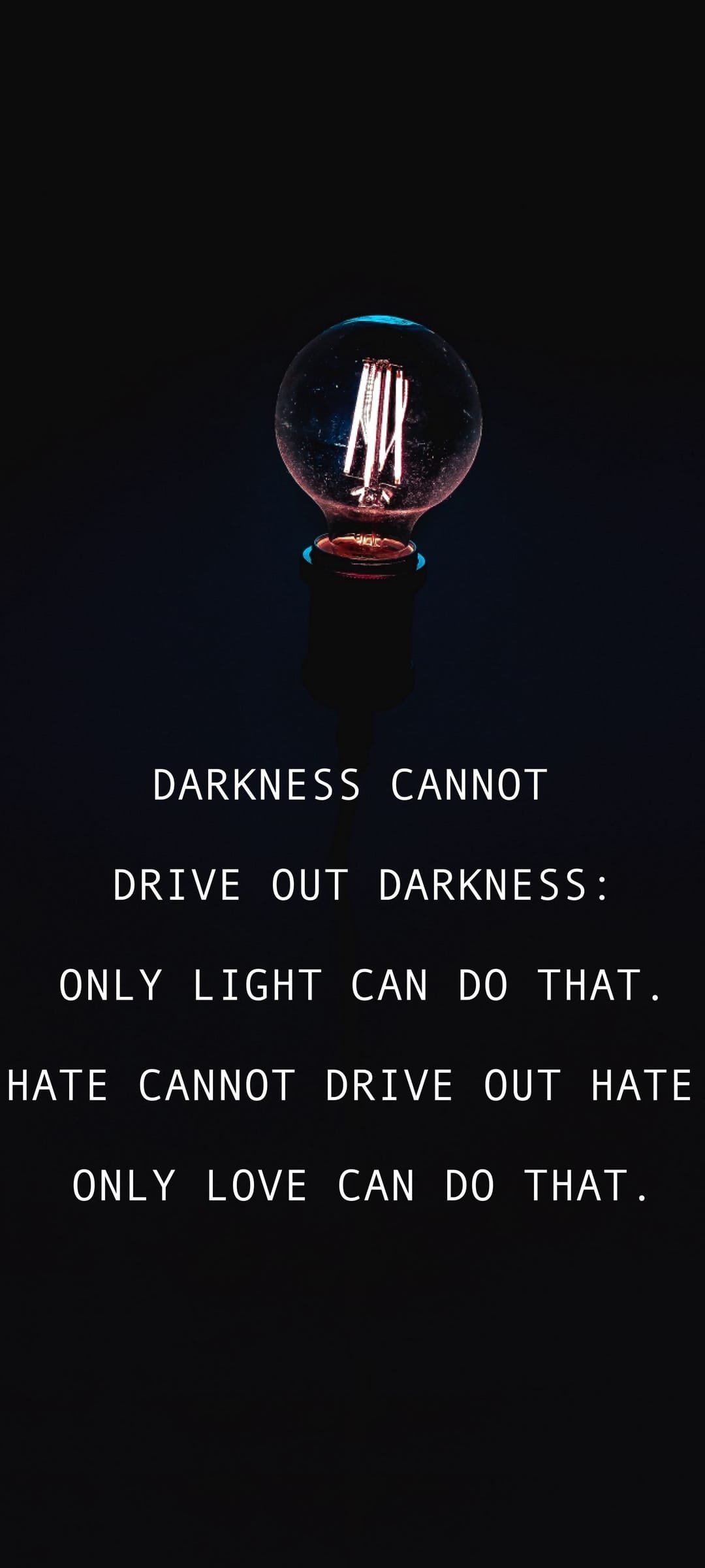 Glowing vintage lightbulb with an intricate filament shining against a dark background with text overlay.